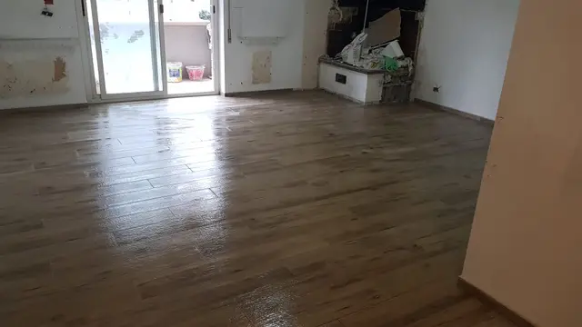 Pardoseală din gresie imitație lemn într-o cameră renovată